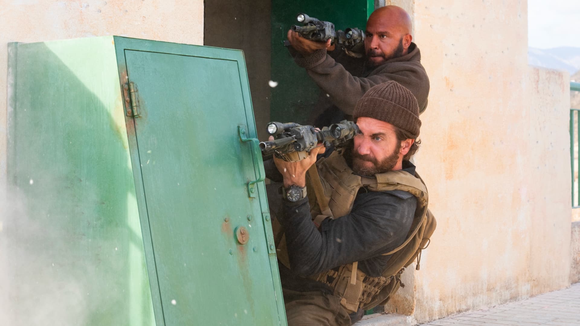 John Kinley (Jake Gyllenhaal) & Ahmed (Dar Salim) engaged in an intense battle with the Taliban in Guy Ritchie's The Covenant (2023).