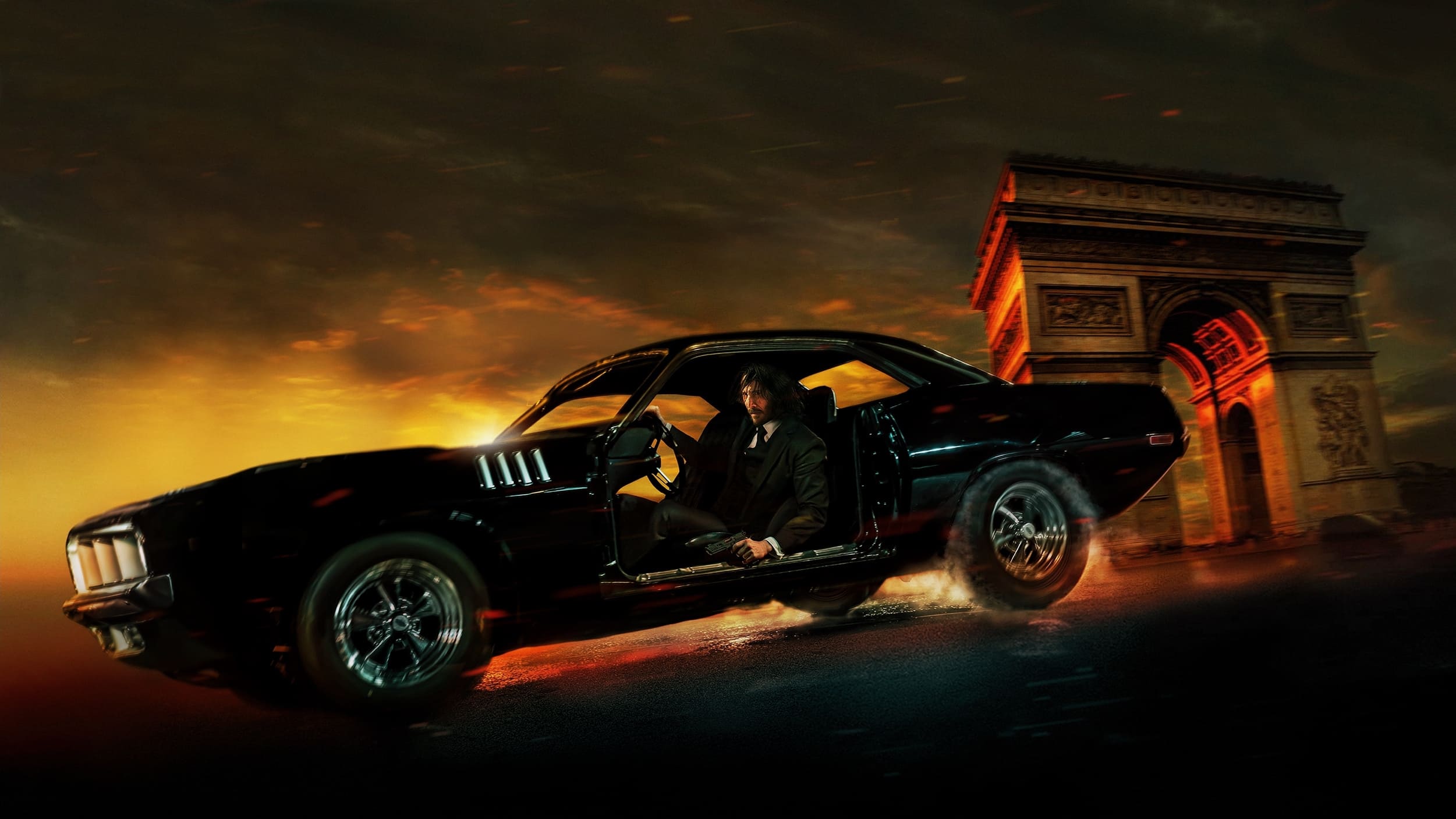 John Wick in his American Muscle Car sans doors in the middle of a car chase action scene. A still shot from the movie John Wick: Chapter 4